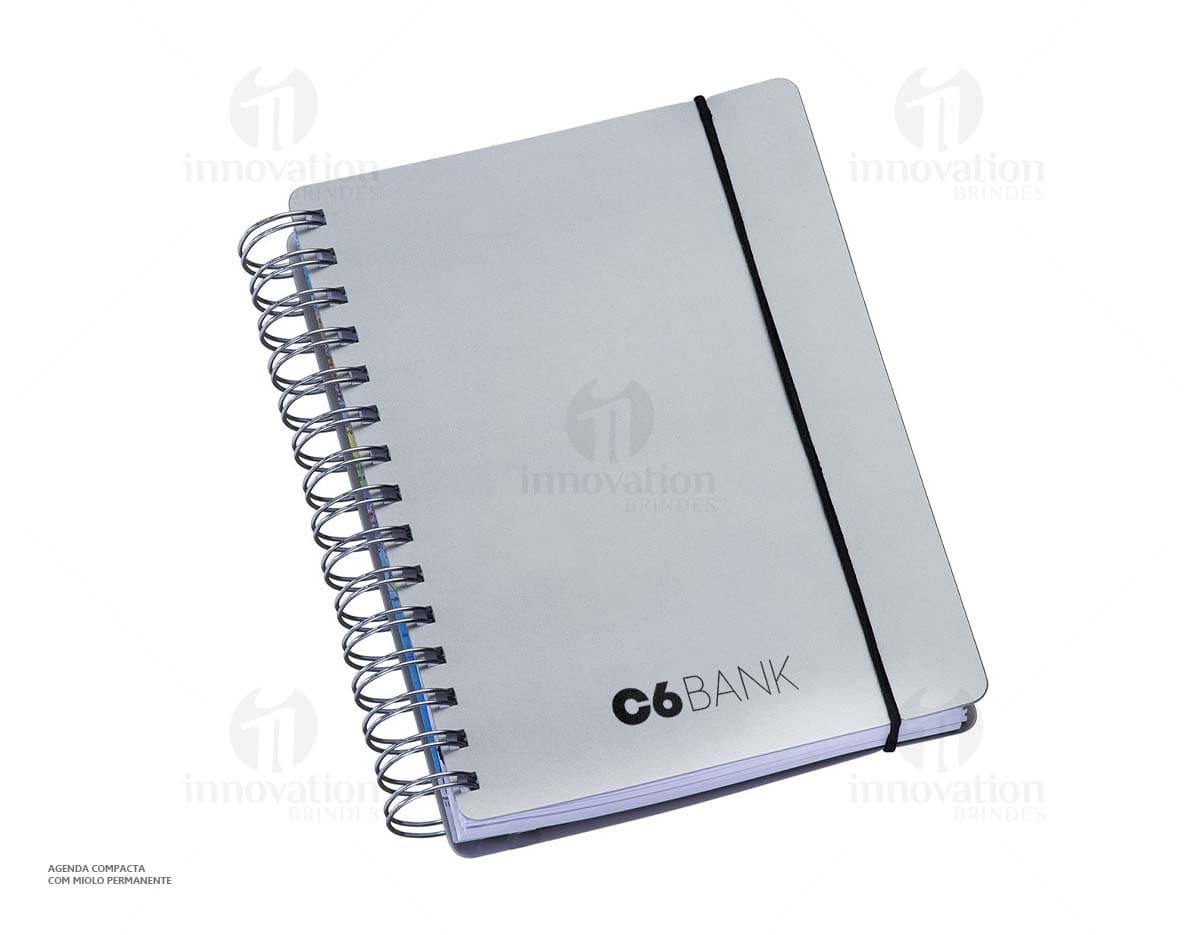 Agenda compacta com acabamento Wire-o, elástico na cor azul e peso de 63g.