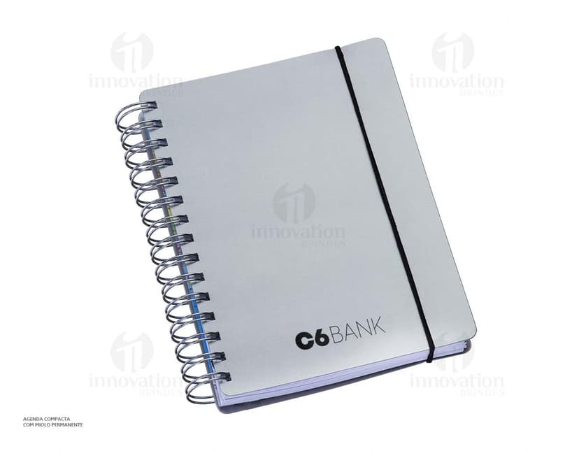 Agenda compacta com acabamento Wire-o, elástico na cor azul e peso de 63g.