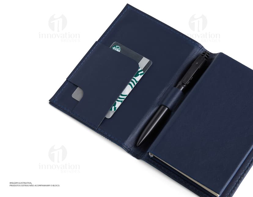 Bloco de anotações com porta caneta em um escritório vazio. O caderno está aberto em uma página em branco e ao lado há um videodisco. O design é moderno e conta com um espaço para guardar objetos, como canetas. O ambiente é limpo e organizado, com um ar de nostalgia.