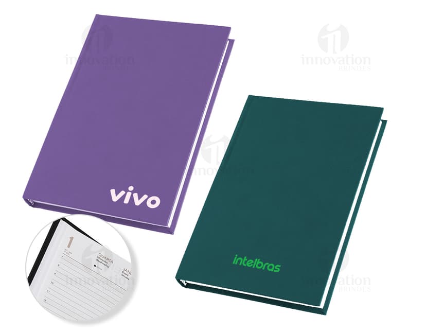 Agenda 2025 Cromato com capa dura na cor prateada e detalhes em relevo. Páginas internas contendo calendários e espaços para anotações.