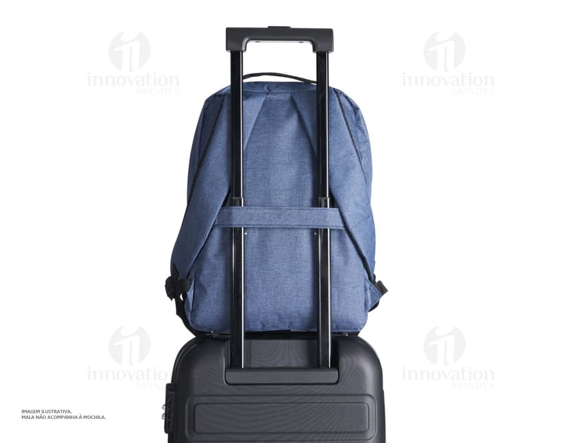 Homem de negócios usando um dispositivo eletrônico em um avião, com uma mochila de nylon preta nas costas. O bolso da mochila contém um cabo USB e há um jeans preto amarrado ao redor da alça.
