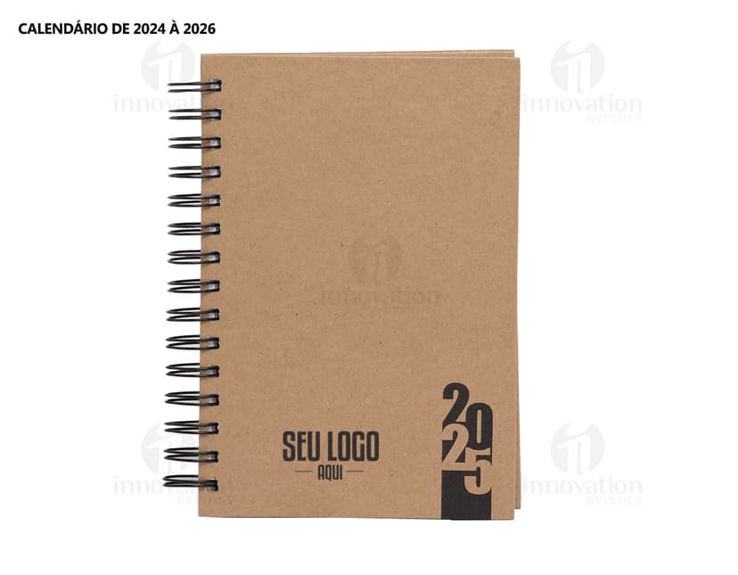 Foto de uma agenda diária para o ano de 2025, com capa marrom e textura de papel antigo. A agenda possui espiral, páginas em branco, listras amarelas e detalhes vintage. No fundo, um quadro antigo e desgastado complementa a composição.