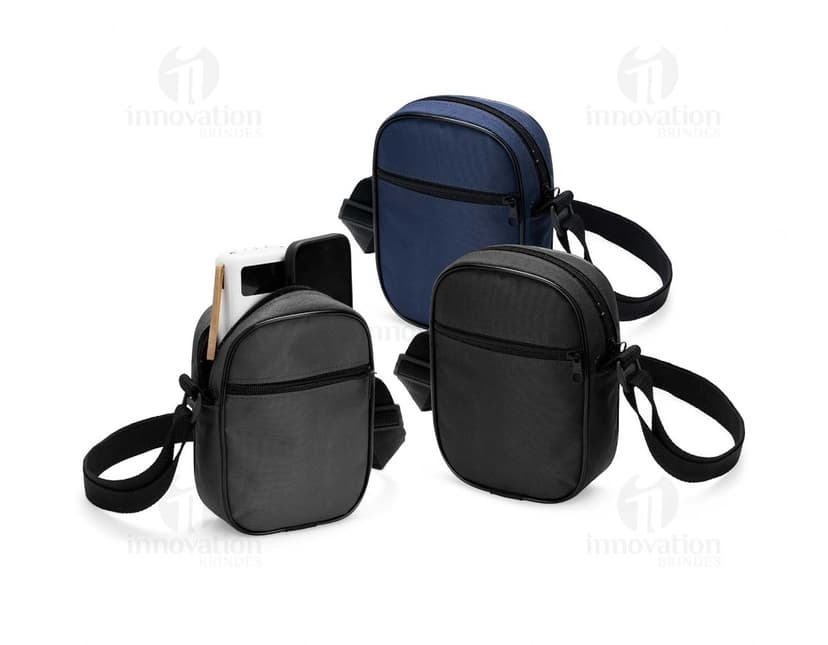 Bolsa de ombro de poliéster preta com alça de couro, fecho metálico, equipada com bolso interno e design moderno. Ideal para viagens e uso diário.